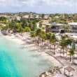 caribbean beaches blue water and huts on sand