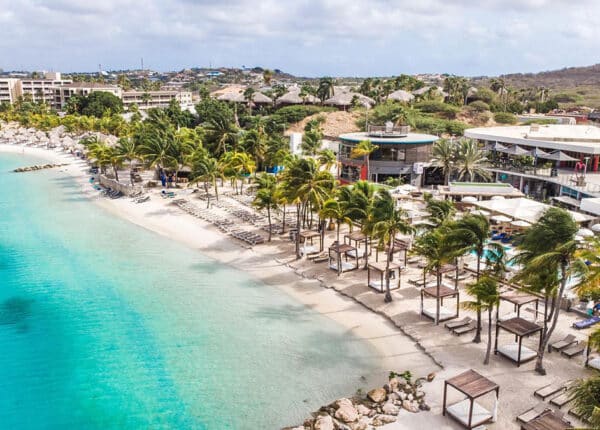 caribbean beaches blue water and huts on sand