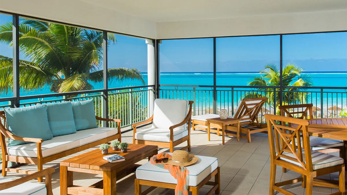 terrace with blue water in background and chairs