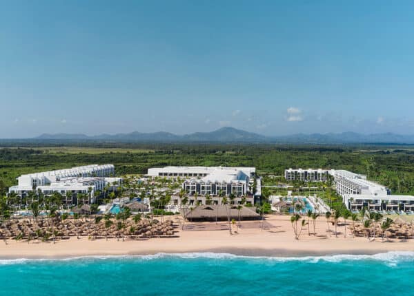 punta cana beach with resort and mountains in background