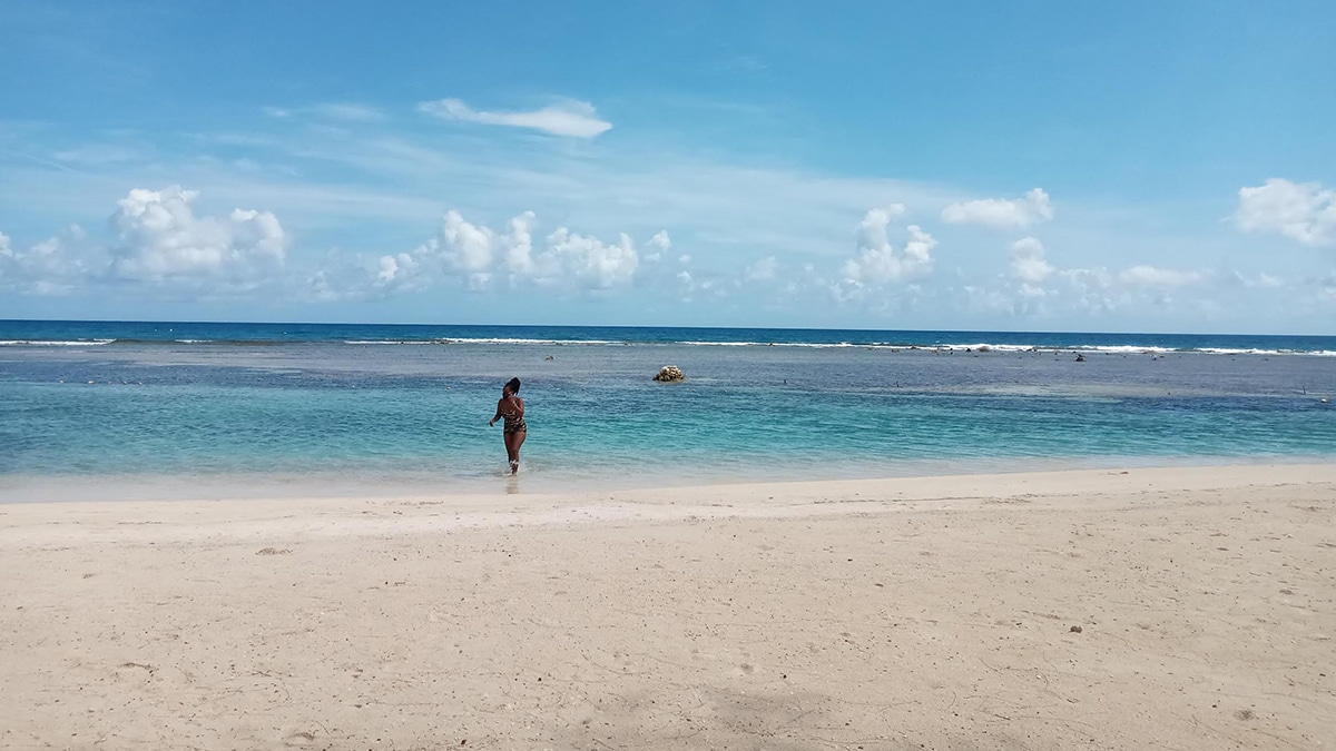 swimmer in bathing suit on beach in jamaica