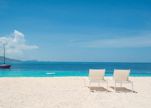 palm island grenadines chairs on beach