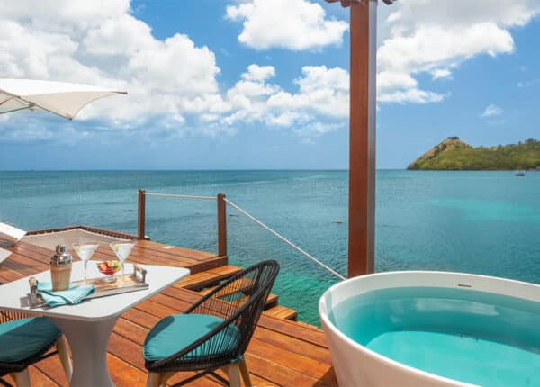 overwater bungalow with pool in view of hills