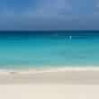 eagle beach in aruba with the waves and blue water