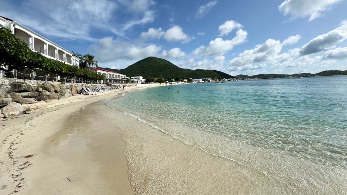 caribbean beach with green mountain