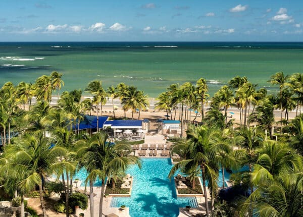 ritz-carlon san juan with pools and palm trees on the beach