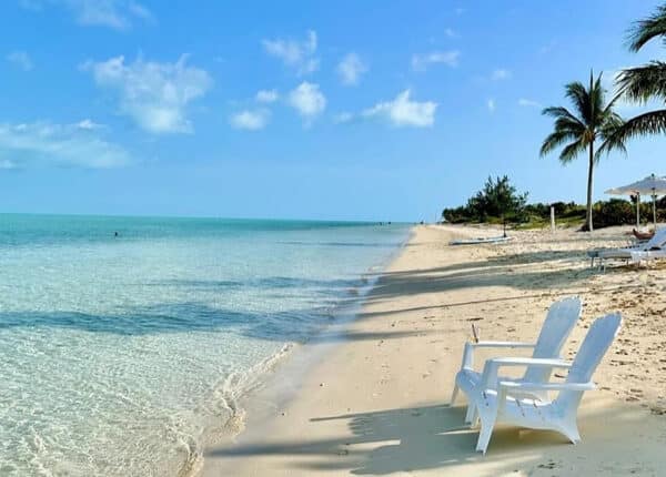 white chairs on the beach in turks and caicos