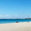 people sitting on seven mile beach in grand cayman