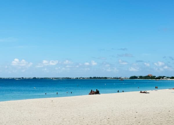 people sitting on seven mile beach in grand cayman